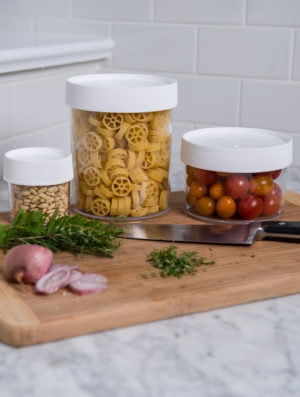 assorted storage jars on top of a cutting board