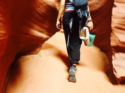 Hiker carrying 32. oz Wide Mouth bottle through slot canyon