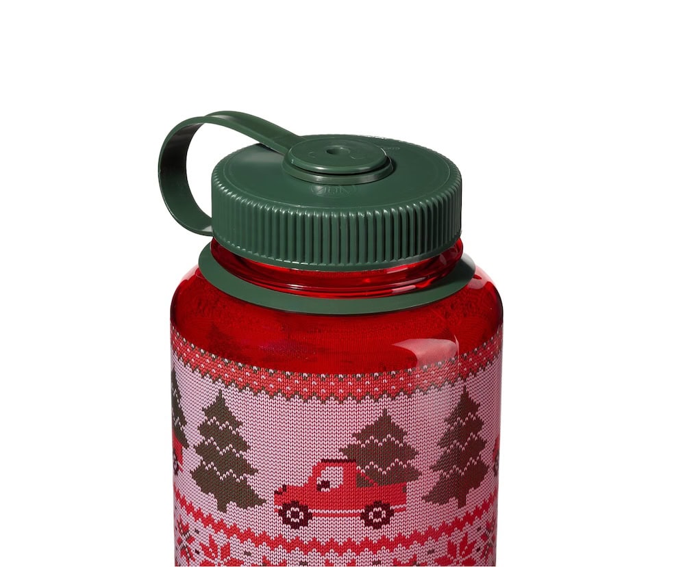 The 32oz Wide Mouth Ugly Sweater Bottle is red with a green lid and features a holiday design of trees and a red truck.