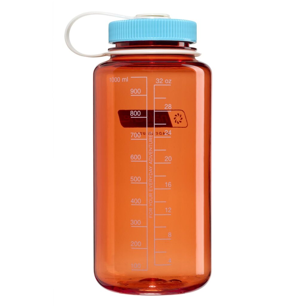 A large orange water bottle with a blue lid and white handle, marked with milliliter and ounce measurements.