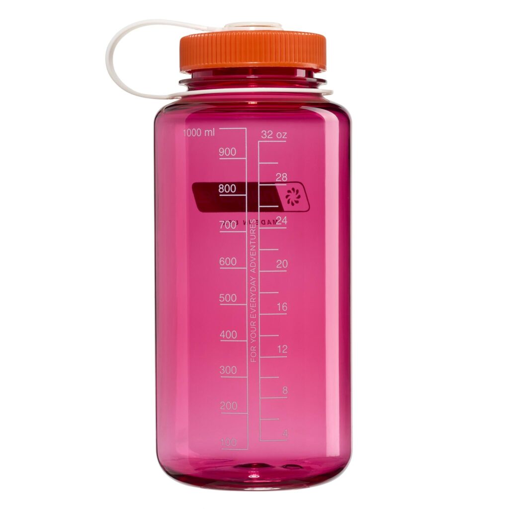 The 32oz WM Thrill in Motion is a clear pink water bottle with an orange lid, white strap, and measurement markings up to 1000 ml (32 oz).