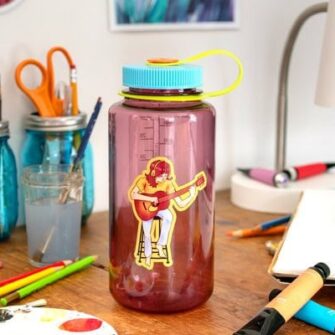 custom water bottle with a sticker of a woman playing the guitar